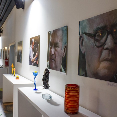Historical photos and glass art display at the academy